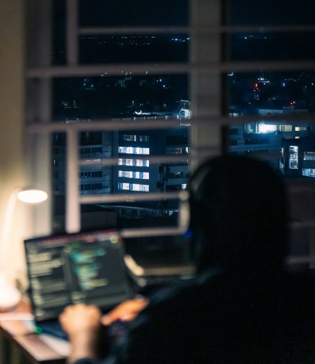 Editor working at a newsroom desk with monitors
